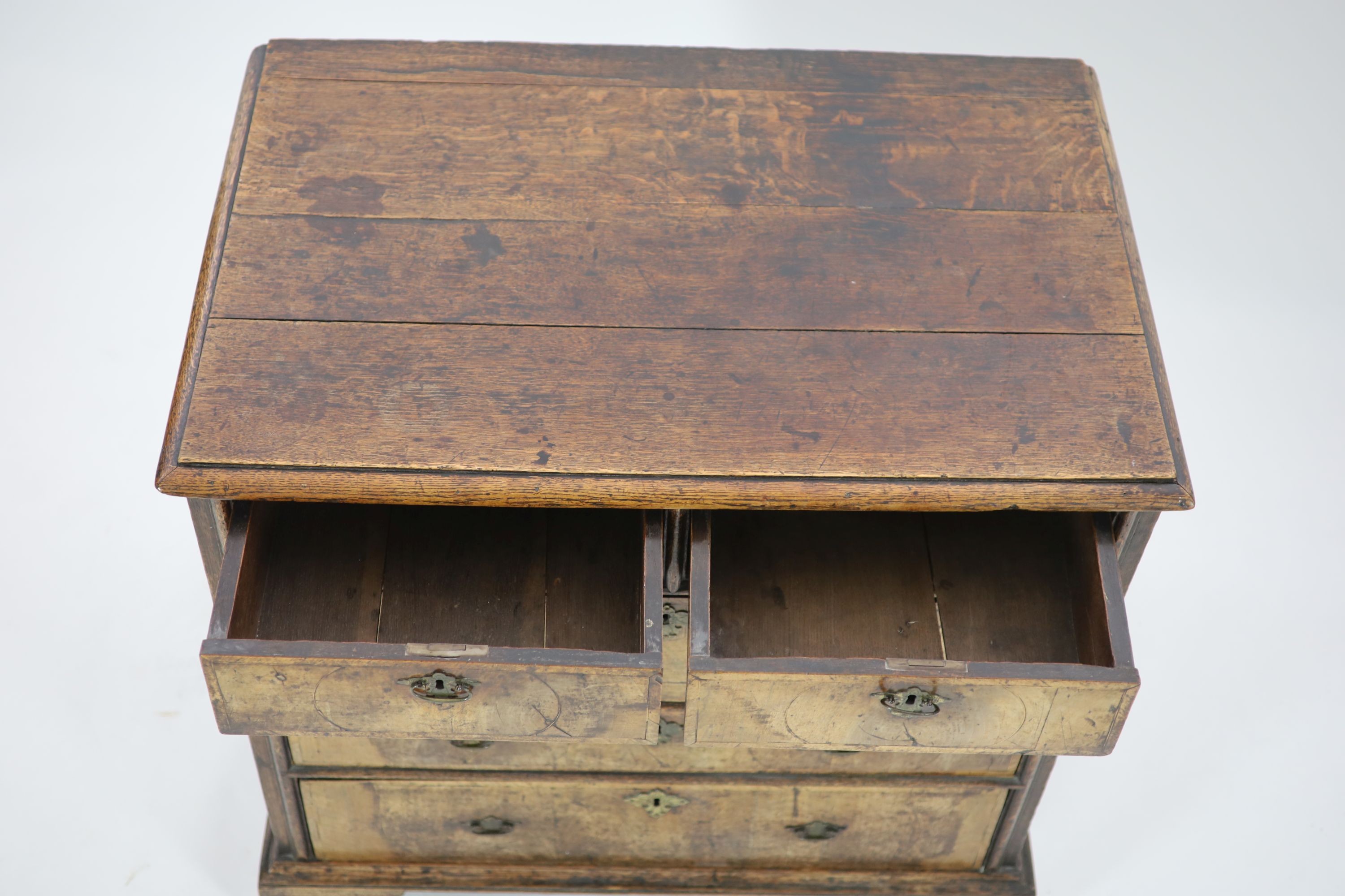 An early 18th century oak and walnut chest, W.94cm D.61cm H.91cm